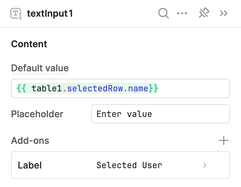 The Text Input component references `{{table1.selectedRow.name}}` to display the selected user.